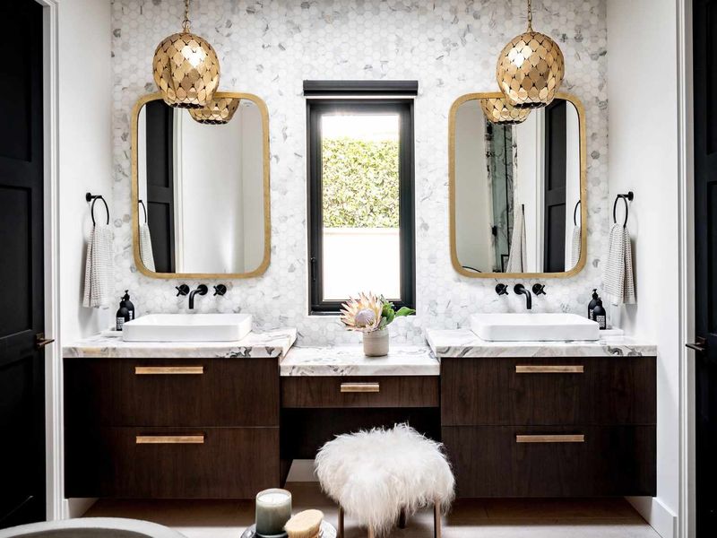 Remodelled bathroom with marble-look tiling, wood vanity and double basins
